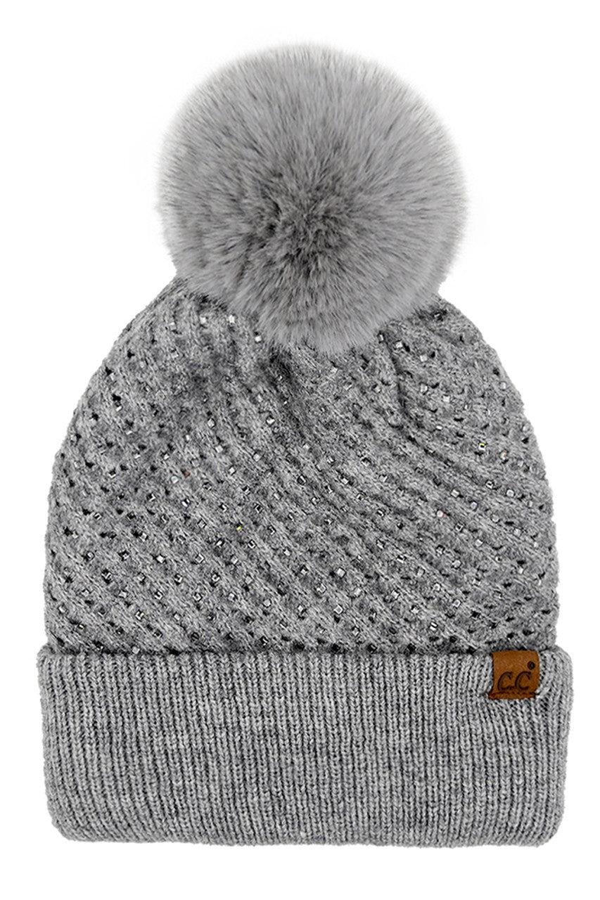 GrayC.C Allover Rhinestone Pom Beanie combines expert craftsmanship with stylish practicality. Crafted from soft, warm knit material, this beanie is adorned with shimmering rhinestones for an elegant yet understated sparkle. The plush pom on top adds a classic touch while ensuring cozy protection against cold weather. Perfect for elevating your winter wardrobe, it offers a refined blend of comfort, durability, and sophistication. 