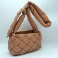Almond This unique handbag features a distinctive woven main compartment crafted with a thick, intertwined design for a modern, textured aesthetic. Perfect for everyday use, the bag is equipped with a generous open-top storage compartment to easily accommodate your daily essentials. A wide, matching puffy shoulder strap features a stylish knot detail near the base, ensuring comfortable carrying while adding a contemporary look to your outfit.
