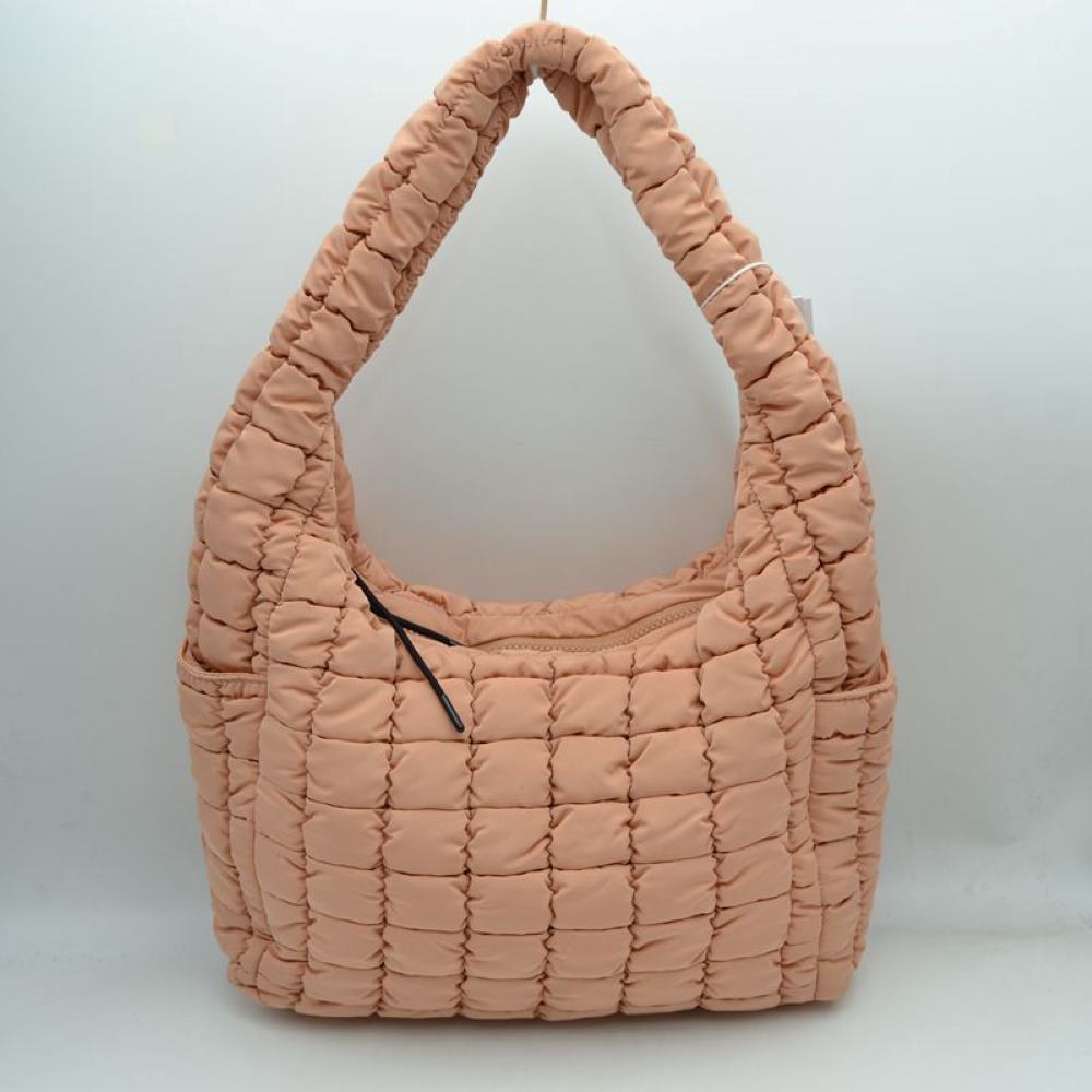 Apricot This trendy hobo shoulder bag features a soft, lightweight puffer exterior with a distinct square quilted pattern in a delicate peach tone, making it a cozy and stylish addition to your everyday look. Designed with a slouchy, crescent-shaped silhouette, it offers a spacious main compartment secured by a top zipper closure with minimalist pull cords. For quick-access organization, it is equipped with convenient open slip pockets on both sides