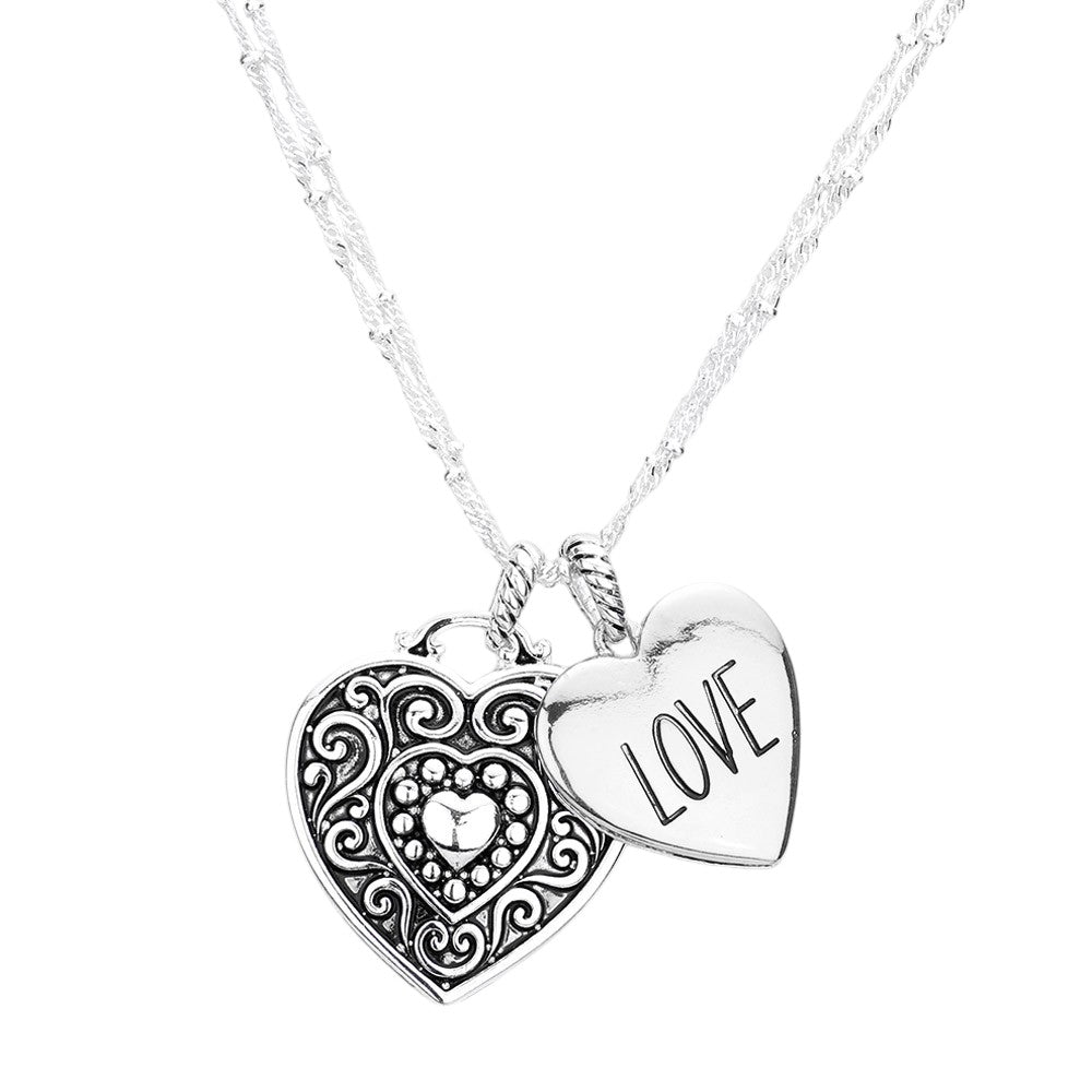 Antique Silver LOVE Antique Metal Heart Pendant Necklace is a charming piece of jewelry that adds a vintage touch to any outfit. Crafted with antique metal, the heart pendant is an elegant and delicate design. The perfect gift to express your love.