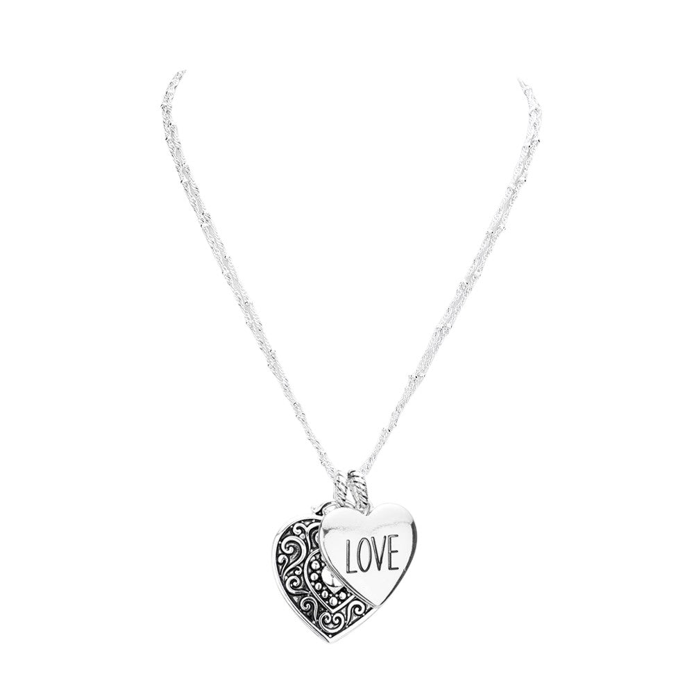 Antique Silver LOVE Antique Metal Heart Pendant Necklace is a charming piece of jewelry that adds a vintage touch to any outfit. Crafted with antique metal, the heart pendant is an elegant and delicate design. The perfect gift to express your love.