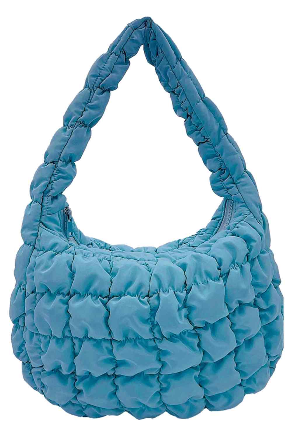 Aqua Compact quilted bag crafted from durable 100% polyester with a timeless solid design. Measuring 8.7" x 11.8" x 3.15", it's the perfect size for everyday essentials, travel accessories, or as a versatile organizer. The quilted texture adds visual interest and subtle structure. Ideal for on-the-go convenience with a sleek, minimalist aesthetic that pairs effortlessly with any outfit.