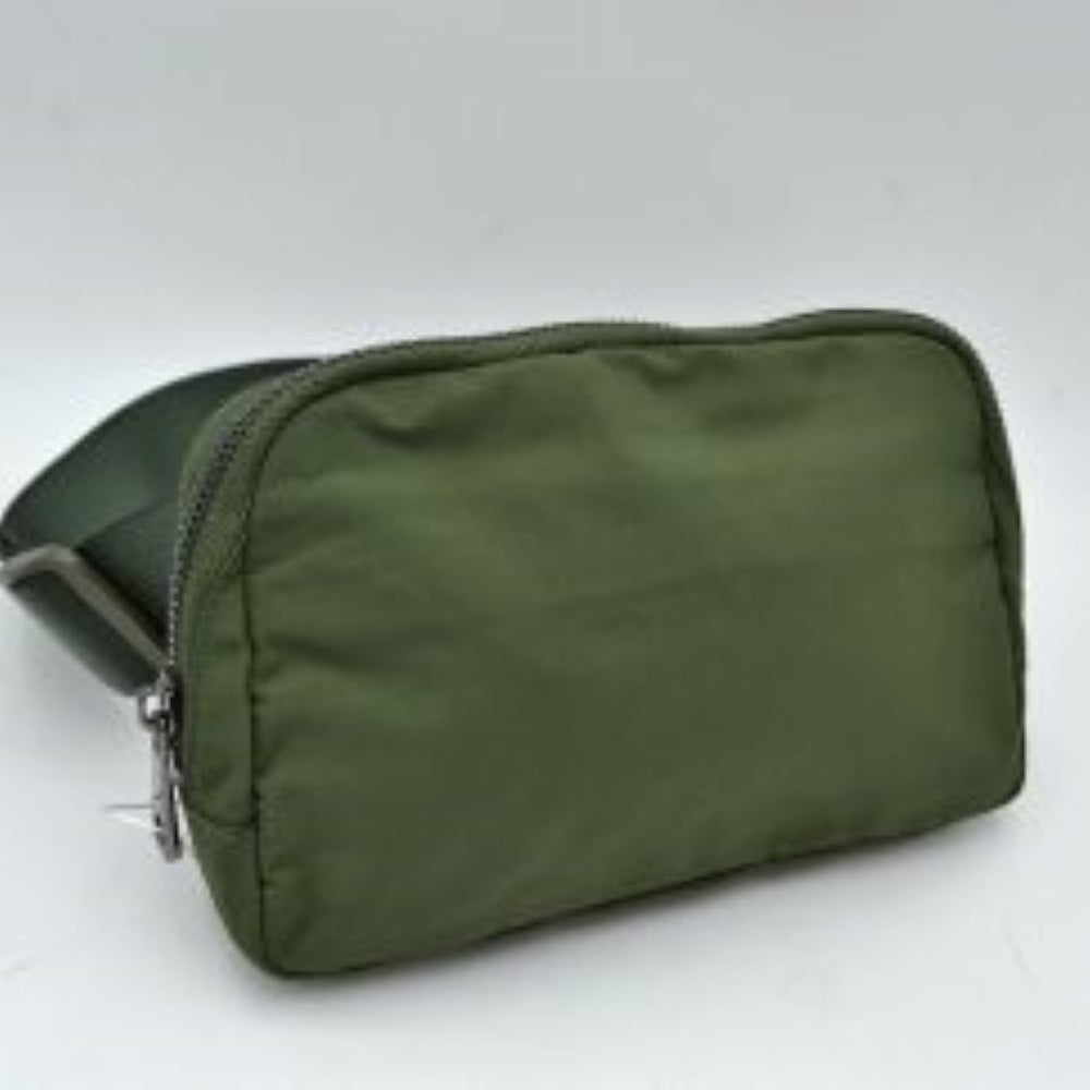 Army dark green This minimalist bag features a smooth, clean design ideal for versatile everyday use. The main storage compartment is secured by a curved top zipper with dual pulls for easy access to essentials. A wide, adjustable strap extends from the sides, complete with a matching slider to easily customize the fit for comfortable carrying.