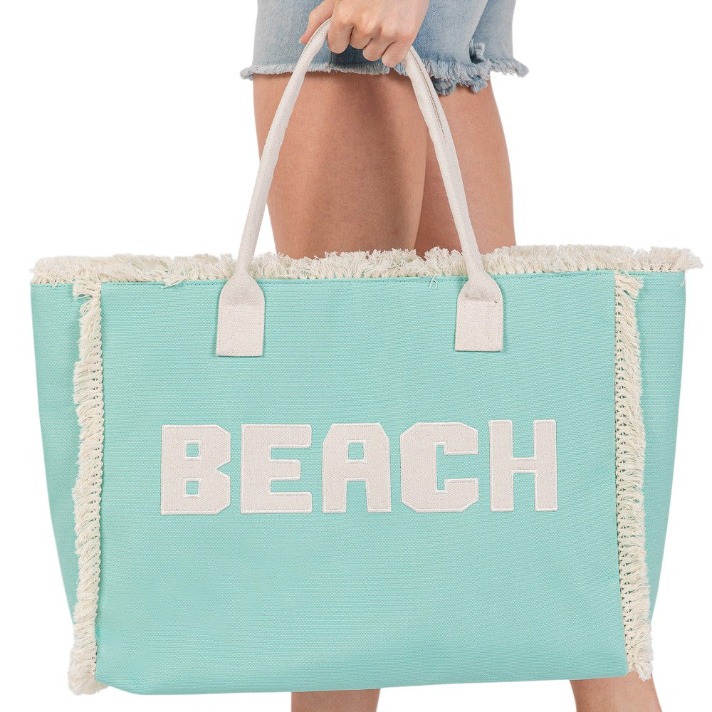 Mint BEACH Message Embroidered Fringe Tote Bag / Beach Bag is perfect for any beach day. With its spacious interior and stylish embroidered fringe detailing, it's both functional and fashionable. Carry all your beach essentials in one convenient and trendy tote. 