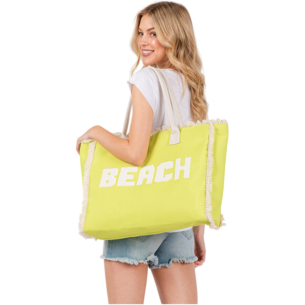 yellow BEACH Message Embroidered Fringe Tote Bag / Beach Bag is perfect for any beach day. With its spacious interior and stylish embroidered fringe detailing, it's both functional and fashionable. Carry all your beach essentials in one convenient and trendy tote. 