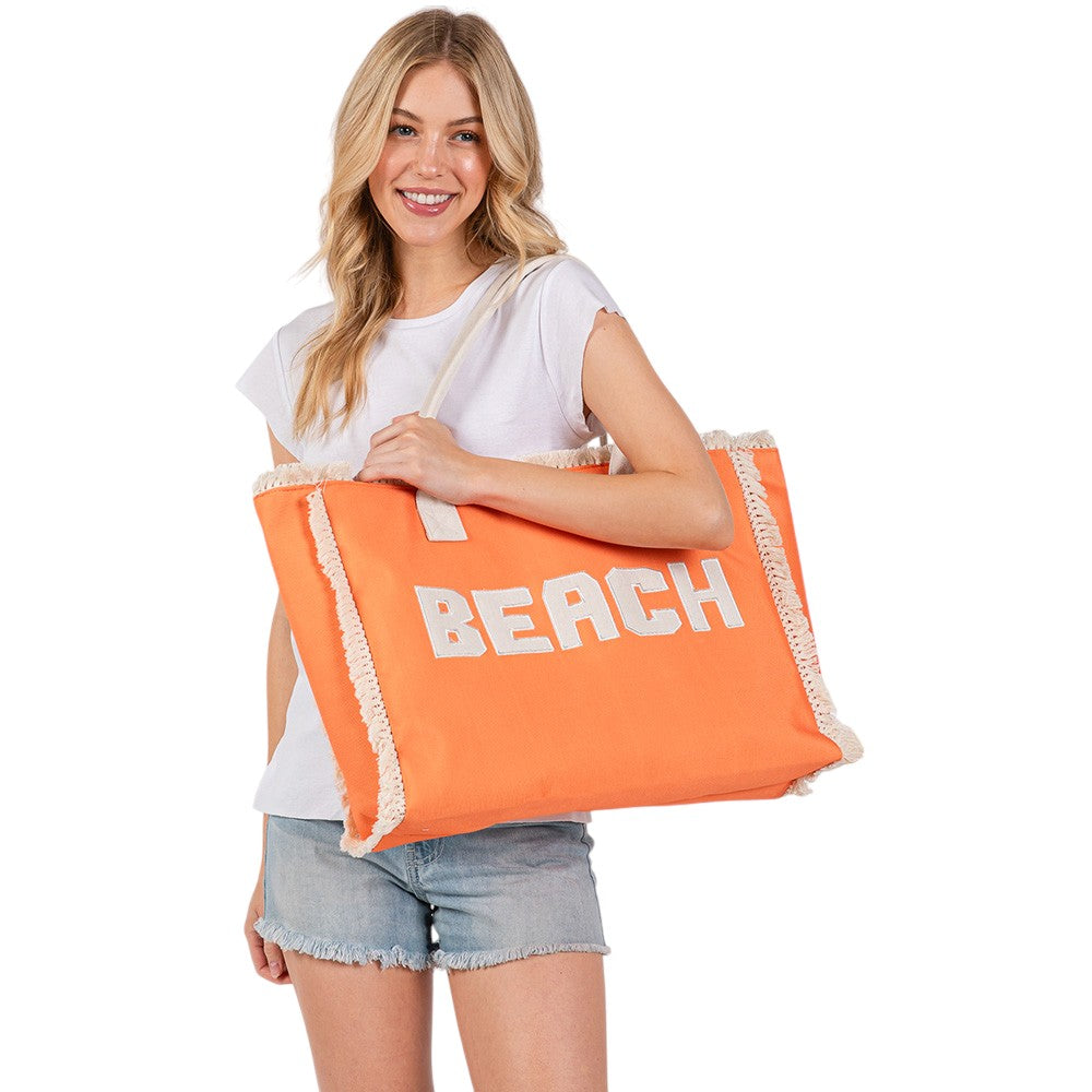 Orange BEACH Message Embroidered Fringe Tote Bag / Beach Bag is perfect for any beach day. With its spacious interior and stylish embroidered fringe detailing, it's both functional and fashionable. Carry all your beach essentials in one convenient and trendy tote. 