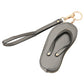 Bronze Faux Leather Flip-flop Mini Wristlet Bag Charm Coin Purse offers a convenient and stylish way to carry your essentials. Made from durable faux leather, this mini wristlet bag doubles as a charm for your larger bag. Keep your coins, keys, or credit cards easily accessible with this sleek and functional accessory.