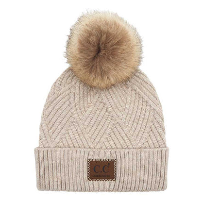Beige C.C Heather Beanie Hat With Pom Pom And Suede Patch, provides excellent protection and a fashionable look with its soft heather knit material, faux fur pom pom, and stylish suede patch. The fabric is designed to keep you comfortably warm in cold weather. Add this fashionable accessory to the winter wardrobe collection.