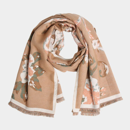 A soft scarf featuring an elegant floral print with a bordered edge and fringe finish. Lightweight yet cozy, this versatile accessory brings warmth and a touch of sophistication to casual and dressy outfits.