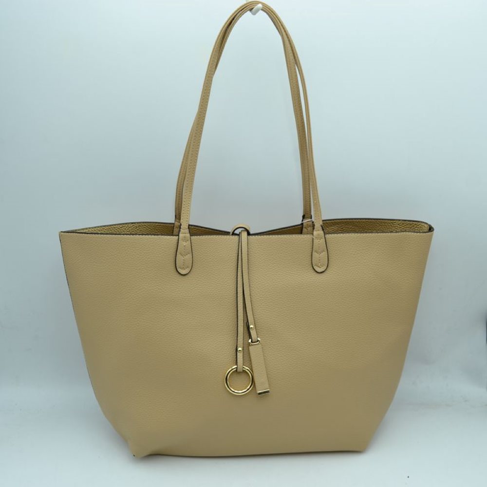 Beige-Gold This classic tote bag features a smooth exterior finish with a timeless trapeze silhouette, offering an elegant look for everyday use. Designed with an open top for quick access, the spacious main compartment provides ample storage space for daily essentials. Dual slim shoulder handles are securely stitched to the upper panels, while a decorative central drawstring tie accents the front, complete with a metallic ring and matching tab accent for a polished touch.