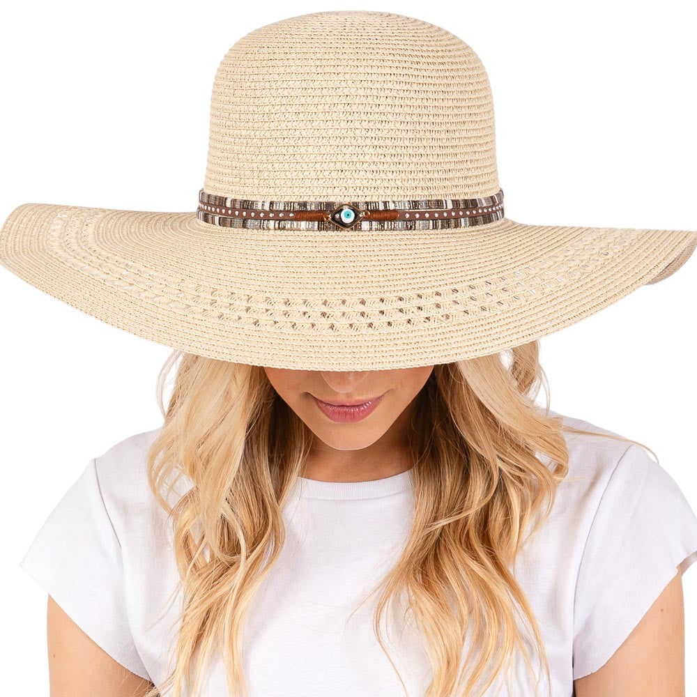 Beige Wide Brim Straw Sun Hat with Evil Eye and Multi Design Band offers stylish sun protection with its unique evil eye and multi-design band. Its wide brim provides ample shade while the evil eye brings a touch of charm. Stay safe from the sun while adding a fashionable touch to your outfit. 