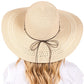 Beige Wide Brim Straw Sun Hat with Evil Eye and Multi Design Band offers stylish sun protection with its unique evil eye and multi-design band. Its wide brim provides ample shade while the evil eye brings a touch of charm. Stay safe from the sun while adding a fashionable touch to your outfit. 