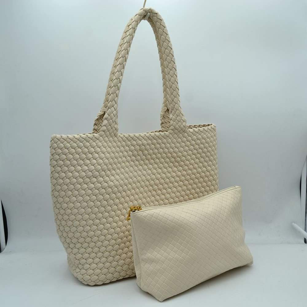 Beige This structured tote bag features an intricate basket-weave design across its body and integrated shoulder straps, creating a textured look suitable for everyday use. The main storage compartment offers a wide, open-top design for easy access to daily essentials. Accompanying the larger bag is a matching smaller pouch with a distinct woven exterior pattern and a secure gold-tone top zipper closure to keep smaller items organized.