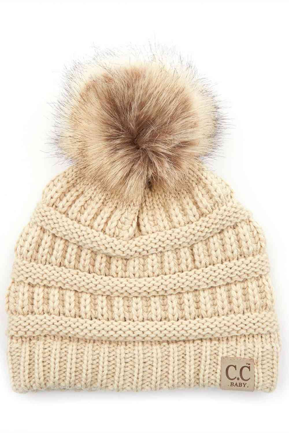 Beige Keep your little one warm and cozy with this C.C Solid Ribbed Infant Beanie. Made from 100% acrylic, the soft ribbed knit construction provides gentle comfort against delicate skin while the natural fur pom adds a charming detail.