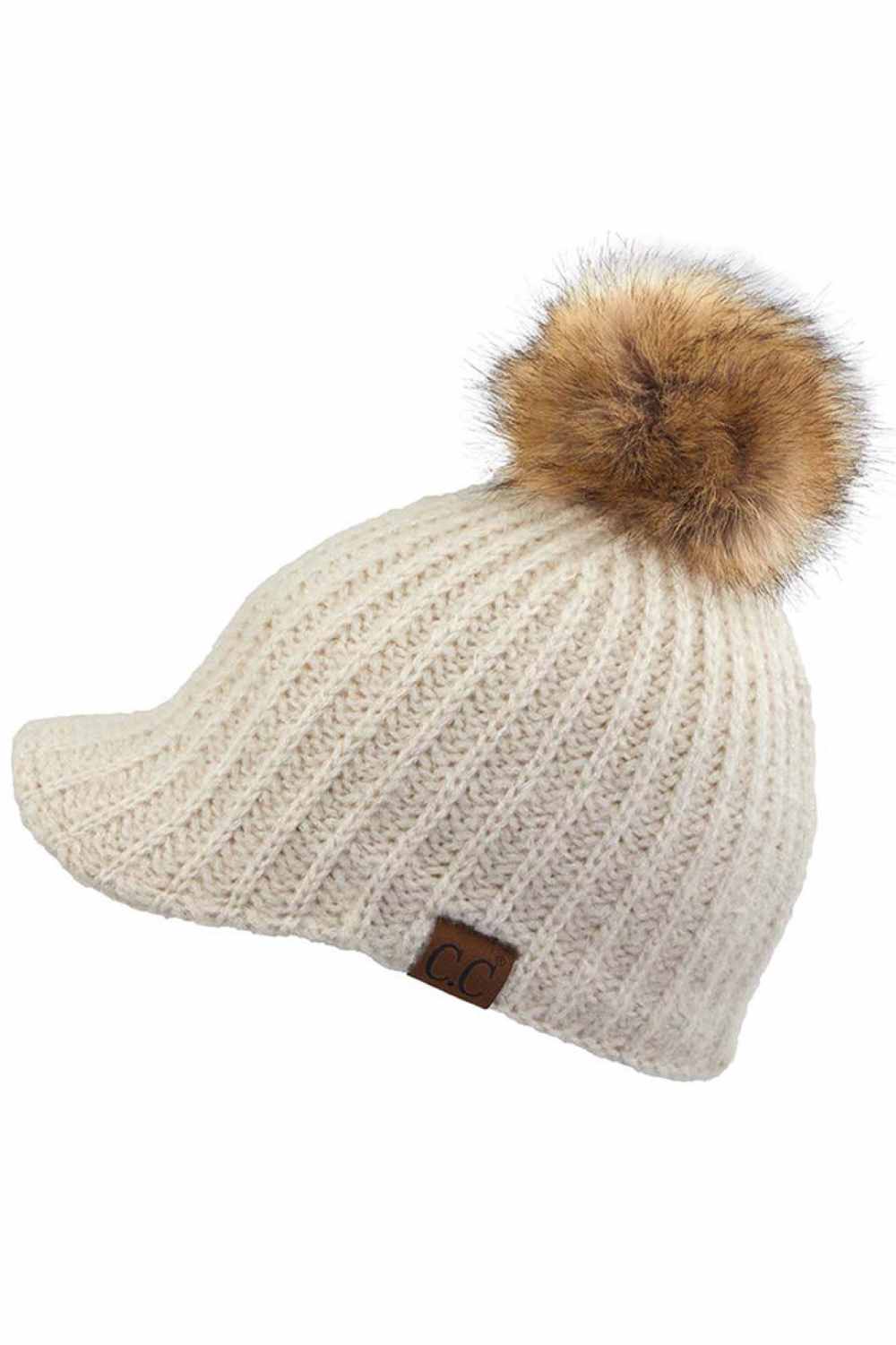 Beige Stay cozy with this knitted brim beanie featuring a plush pom pom detail. Crafted from a soft blend of 75% acrylic, 22% polyester, and 3% spandex, this winter essential delivers warmth and comfort in a versatile style. Available in nine rich colors including Beige, Berry, Dark Denim, Heather Gray, Ivory, Pistachio, Rose, Steel Blue, and Violet Purple. The ribbed knit construction and faux fur pom add texture and visual interest to any cold-weather outfit. Hand wash and lay flat to dry for lasting qual