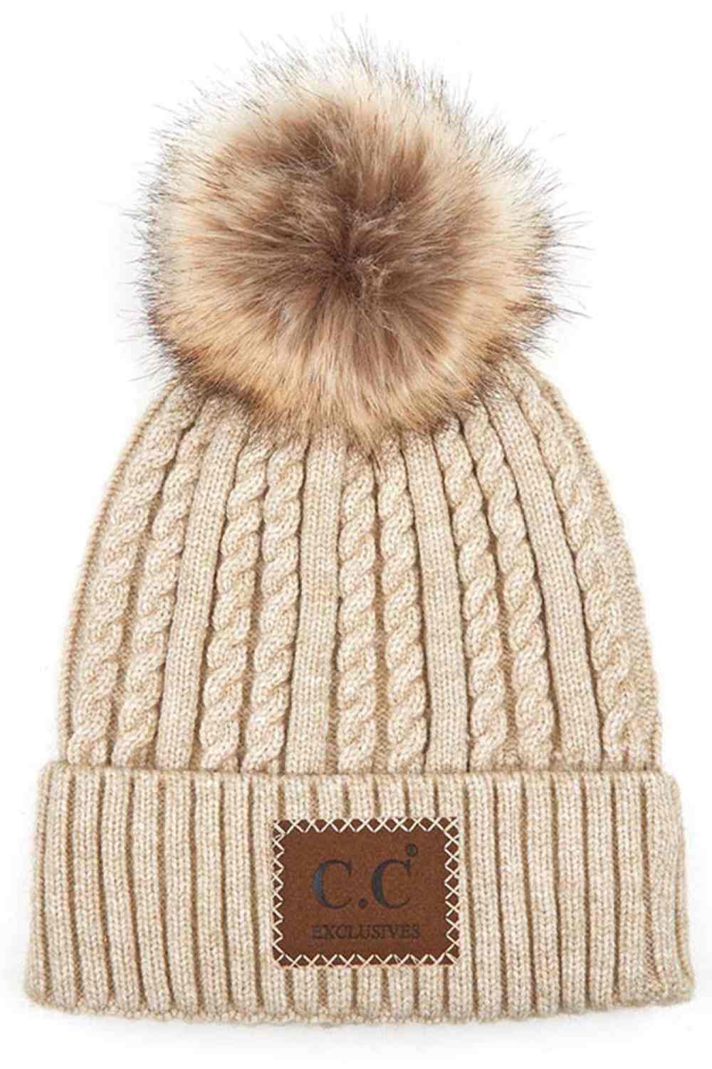 Beige Stay warm and stylish with the C.C Double Braided Beanie, featuring a cozy pom-pom and iconic C.C leather patch. Crafted from a durable blend of 75% acrylic and 25% nylon, this beanie offers comfort and longevity through every season.