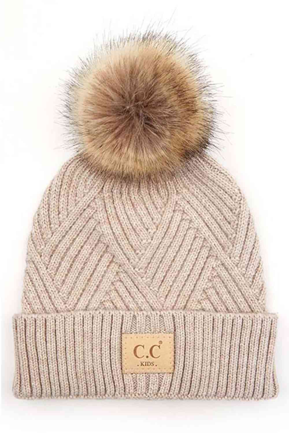 Beige Keep your little one cozy with this C.C Kids Knit Beanie, featuring a playful diagonal stripes criss-cross pattern. Crafted from a soft blend of 47% rayon, 31% PBT, and 22% nylon, this beanie offers warmth and durability for everyday wear.
