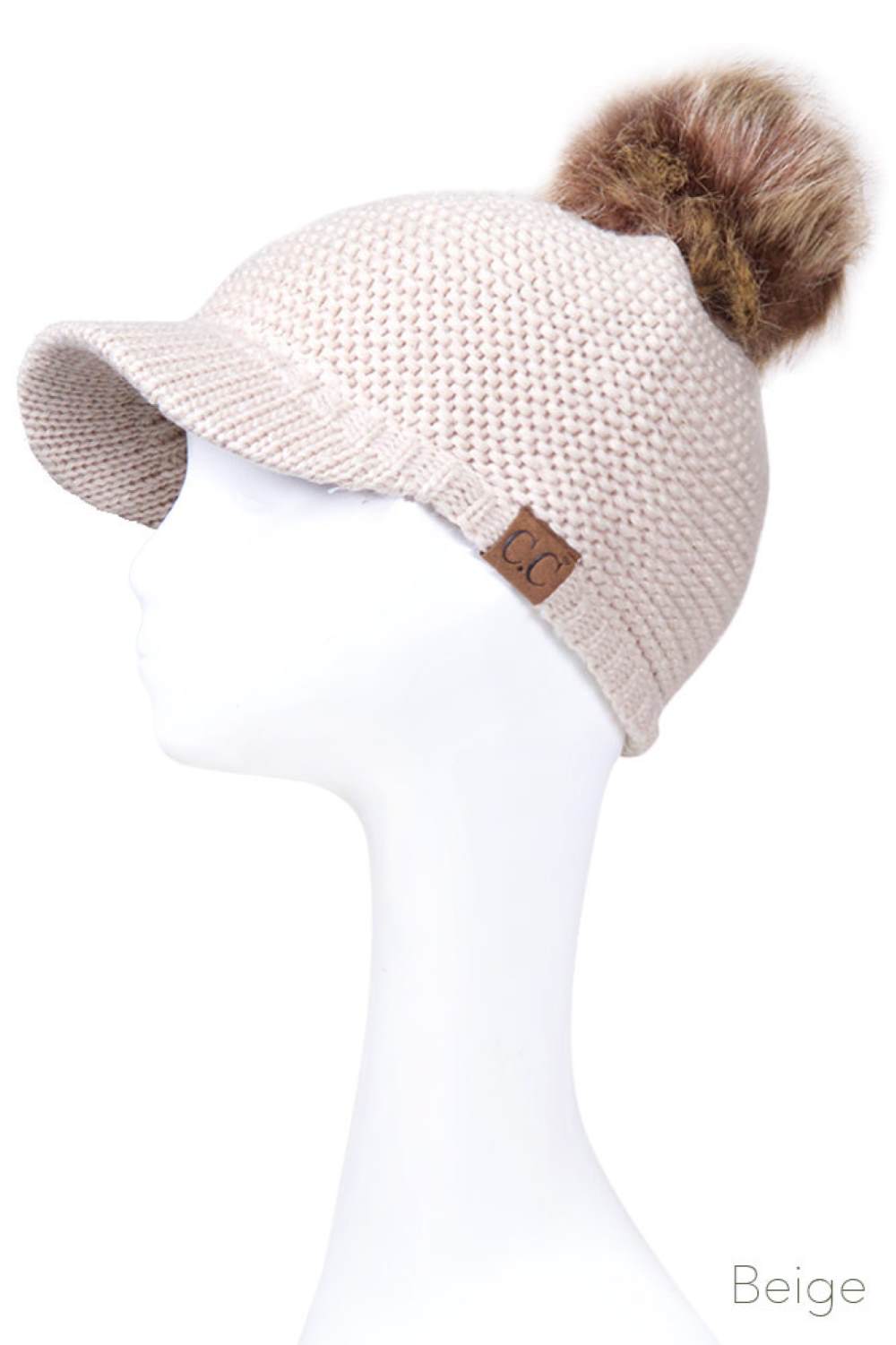 Beige Elevate your winter wardrobe with this versatile C.C knit brim beanie, crafted from 100% soft acrylic for exceptional comfort and durability. The signature knitted brim design pairs beautifully with a plush fur pom pom, adding a touch of sophistication to any cold-weather look. One size fits most, making it an effortless accessory choice for anyone seeking warmth without compromising on style. Perfect for layering or standalone wear, this beanie delivers both functionality and fashion