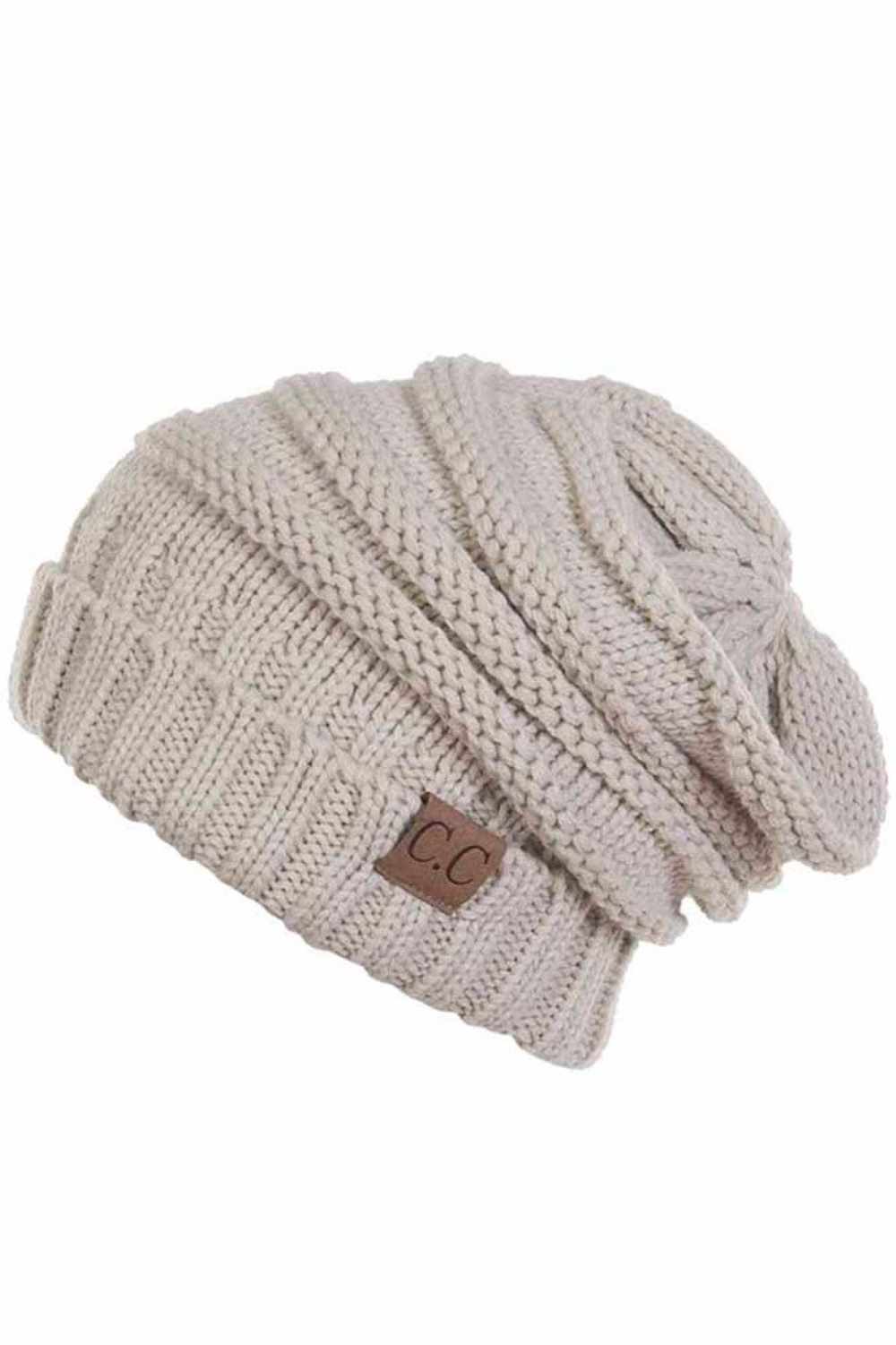 Beige Wrap yourself in warmth with this C.C Slouchy Knitted Beanie, crafted from 100% soft acrylic for ultimate comfort. The oversized silhouette and plush pom pom detail create a relaxed, on-trend look perfect for chilly days. Available in nine versatile colors—Beige, Berry, Dark Denim, Heather Gray, Ivory, Pistachio, Rose, Steel Blue, and Violet Purple—this beanie pairs effortlessly with any winter wardrobe. The ribbed knit construction ensures durability and a flattering fit. Hand wash and lay flat to dr