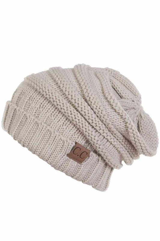 Beige Wrap yourself in warmth with this C.C Slouchy Knitted Beanie, crafted from 100% soft acrylic for ultimate comfort. The oversized silhouette and plush pom pom detail create a relaxed, on-trend look perfect for chilly days. Available in nine versatile colors—Beige, Berry, Dark Denim, Heather Gray, Ivory, Pistachio, Rose, Steel Blue, and Violet Purple—this beanie pairs effortlessly with any winter wardrobe. The ribbed knit construction ensures durability and a flattering fit. Hand wash and lay flat to dr