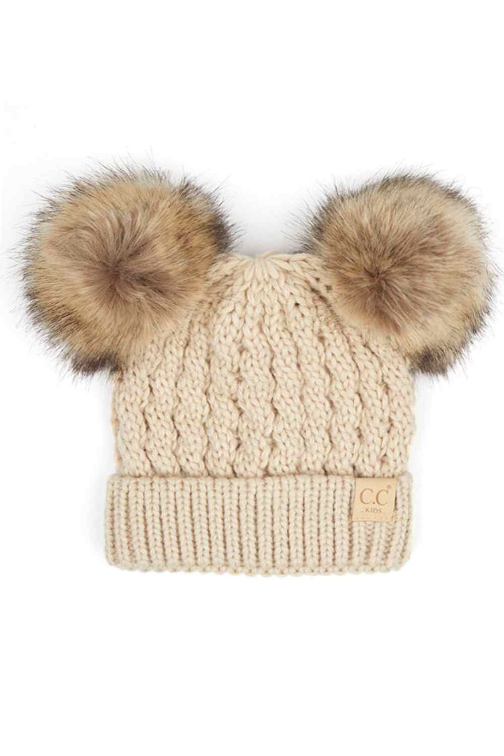 Beige Keep your child warm and stylish with this C.C Kids Double Pom Pom Beanie. Featuring an all-over cable knit pattern and dual pom poms for extra charm, it's the perfect accessory for chilly days.