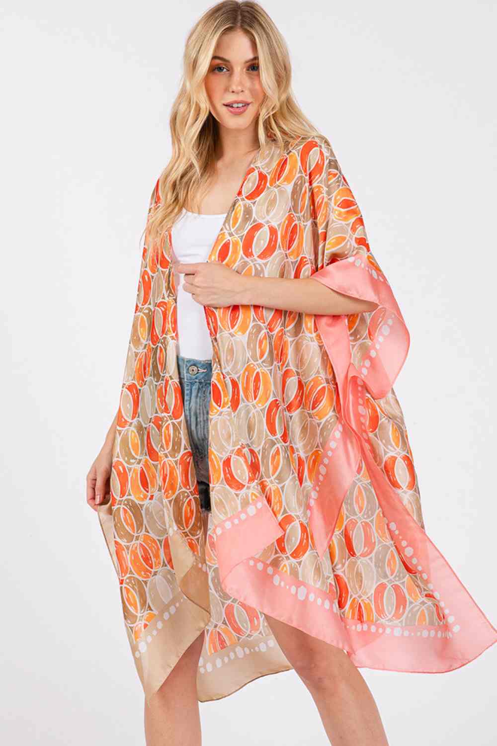 Beige Effortless elegance meets summer style with this Two Tones Trim Abstract Pattern Kimono. Crafted from 100% polyester with a luxuriously silky feel, this lightweight cover-up drapes beautifully over any outfit. The striking abstract pattern and contrasting two-tone trim add visual interest and versatility for beach days, poolside lounging, or casual outings. Generously sized at 35" x 36", it offers comfortable coverage and movement. Perfect for layering during warmer months.