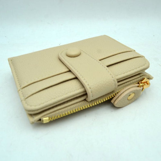 Beige This compact card holder wallet features a textured pebbled exterior in a soft beige tone, providing a sleek and practical design for daily organization. The front panel is equipped with multiple exterior card slots secured by a matching leather strap with a snap button closure. A secure side pocket with a metallic gold-tone zipper and a detailed leather pull tab opens to an internal compartment for coins or folded bills, making it an essential companion for minimalist carrying.