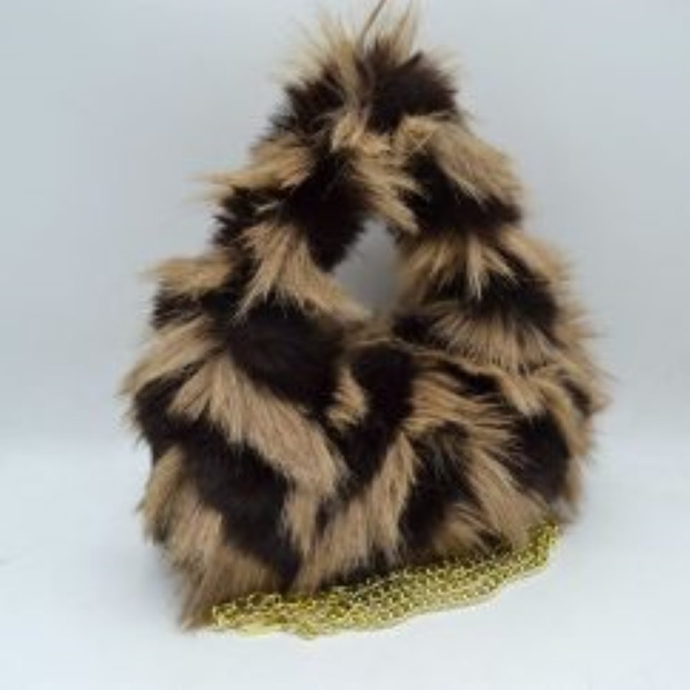 Beige This distinctive everyday handbag showcases a statement-making, long-pile shaggy plush exterior that adds unique dimension and tactile texture to your accessory collection. Designed with a soft, rounded triangular silhouette, it features a built-in top cutout handle for convenient hand carrying, alongside a separate metallic chain strap for versatile alternative styling. The central top opening provides straightforward access to the main storage compartment