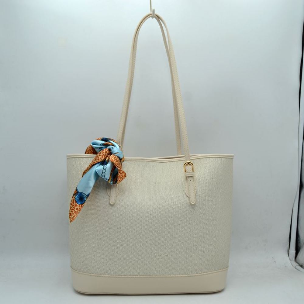 Beige Step out in style with this sophisticated and timeless tote bag. Designed with an understated chevron-style textured weave, this bag seamlessly blends classic elegance with everyday functionality. Perfect for work, travel, or upscale weekend outings, it comes complete with a vibrant, playful silk-style scarf wrapped around the handle for an instant touch of Parisian chic.