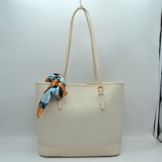 Beige Step out in style with this sophisticated and timeless tote bag. Designed with an understated chevron-style textured weave, this bag seamlessly blends classic elegance with everyday functionality. Perfect for work, travel, or upscale weekend outings, it comes complete with a vibrant, playful silk-style scarf wrapped around the handle for an instant touch of Parisian chic.