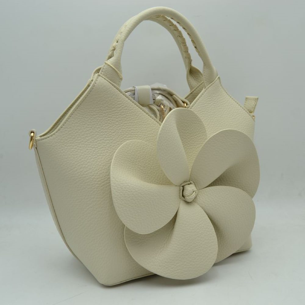 Beige Make a whimsical yet sophisticated statement with this gorgeous winged satchel handbag, designed to bring an artistic and romantic flair to your accessory wardrobe. Crafted with a clean, structural silhouette and an elegant flared-wing shape, the front is beautifully adorned with a prominent, sculptural 3D five-petal flower applique that creates stunning dimension and immediate visual appeal. 