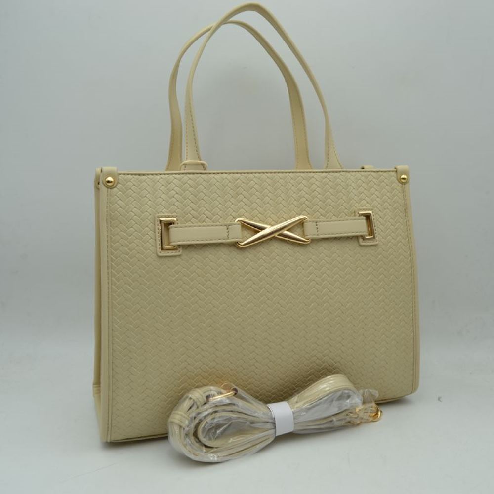 Beige This sophisticated everyday tote bag features a structured rectangular silhouette with an all-over classic basket-weave textured design in a clean beige tone. The front panel is elegantly accented by a matching faux-leather strap detailed with a polished, gold-toned 'X' shaped decorative buckle. Designed for organized professional or daily use, the main compartment is fitted with double slim top handles for comfortable hand or arm carrying.