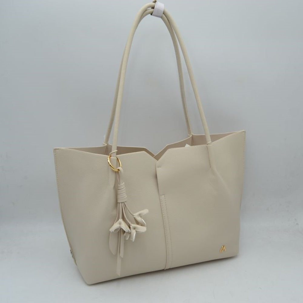 Beiige Bring a clean, contemporary aesthetic to your daily wardrobe with this sophisticated tote bag. Featuring a distinctive geometric cutout design along the upper trim, this shoulder bag offers a modern architectural edge while remaining perfectly functional. The smooth, textured exterior is detailed with subtle vertical center stitching and a small, polished metallic logo accent on the lower corner. Designed for comfort and convenience