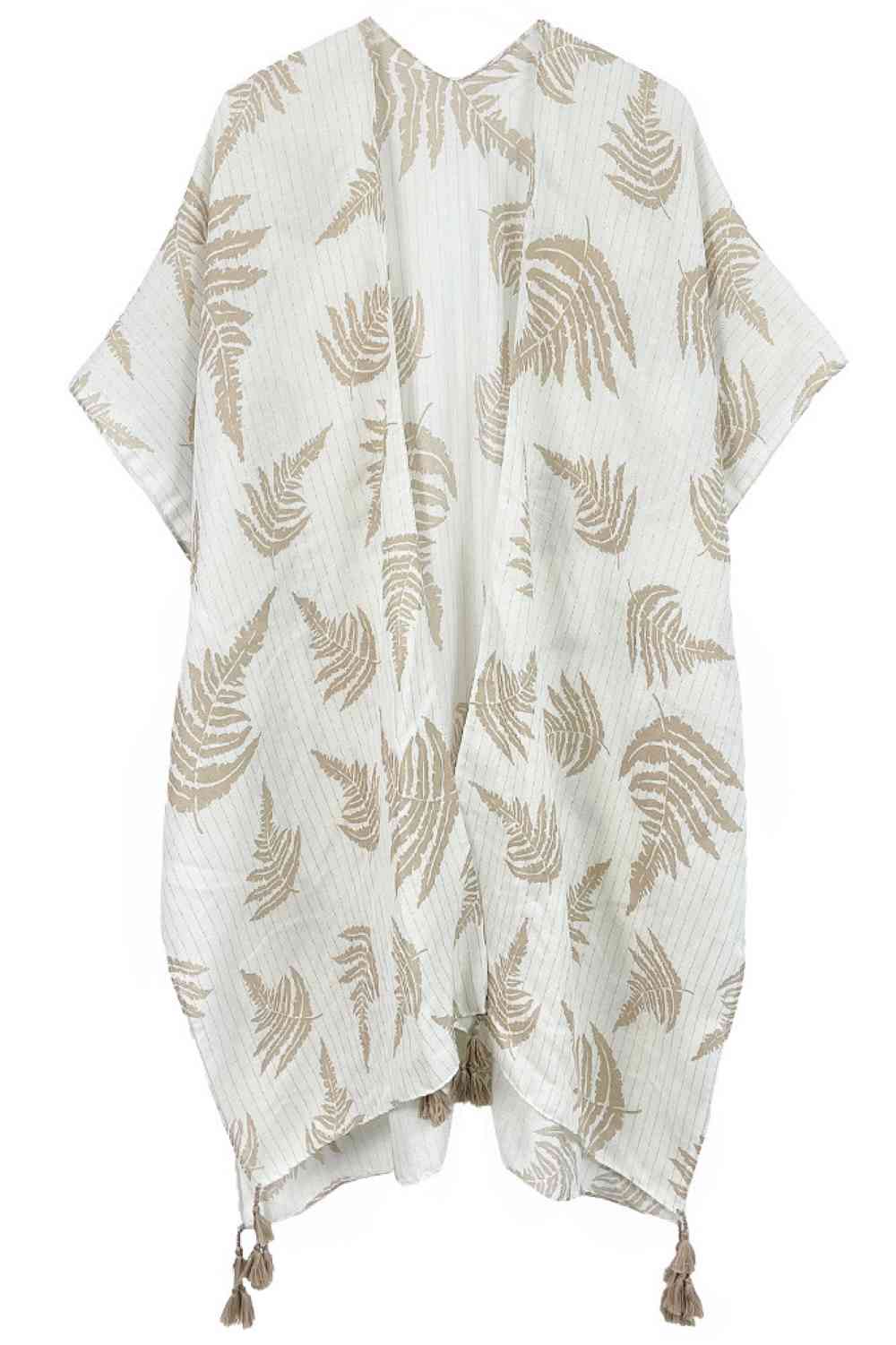 Beige Effortless elegance meets bohemian charm with this stunning leaf print kimono. Crafted from lightweight polyester, it features a sophisticated two-tone design accented with shimmering lurex threading and playful tassels at the hem. The generous 35.4" x 35.4" dimensions provide a relaxed, flowing fit perfect for layering over any outfit. Whether you're heading to the beach, a casual brunch, or an evening out, this versatile piece transitions seamlessly from day to night. A wardrobe essential that bring
