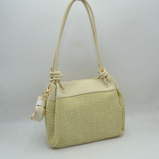 Beige Embrace a relaxed yet sophisticated aesthetic with this beautifully textured shoulder bag. The design prominently features a classic woven mesh panel across the main body, paired seamlessly with smooth trim along the upper edge and base. Dual slender shoulder straps attach to the bag with elegant, integrated knot details at the base, offering a comfortable drop for easy over-the-shoulder carrying. Adding to its versatile utility, a small, matching clip-on zippered pouch hangs from the side hardware