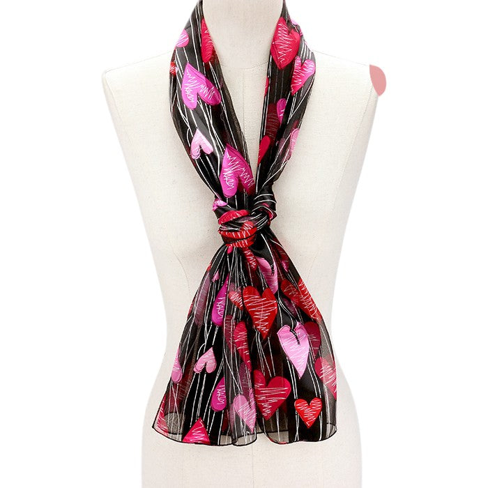 Black Silk Feel Striped Heart Pattern Scarves are designed with a soft and luxurious silk-like material that guarantees comfortable and lightweight wear. The elegant striped heart pattern adds a touch of sophistication to any outfit. Perfect as a gift or a stylish addition to your wardrobe.