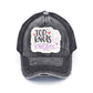 Black C.C DISTRESSED TOP KNOTS AND COFFEE PATCH PONYCAP is an essential accessory for coffee lovers. Made with distressed fabric and a stylish top knot, it also features an embroidered coffee patch. Stay fashionable while showing off your love for coffee.