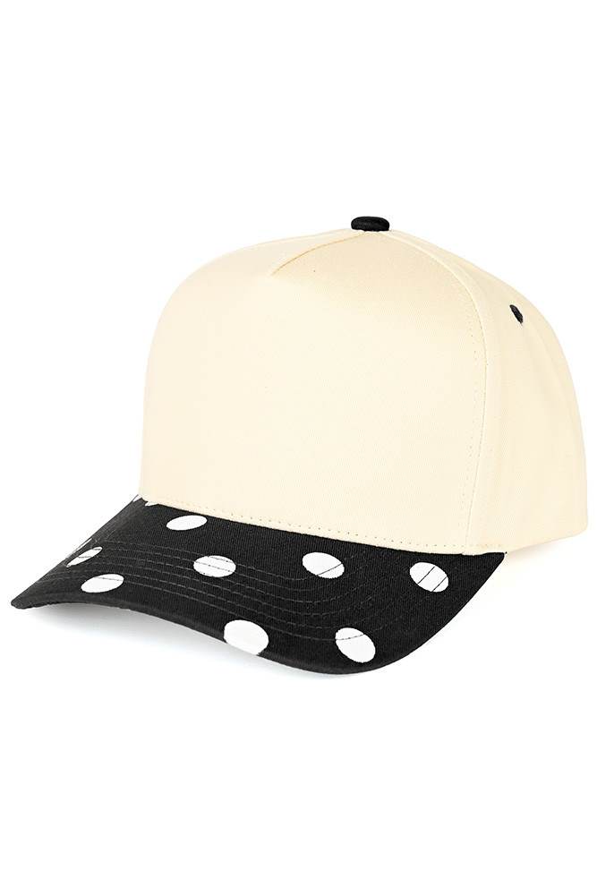 Classic style meets playful design with this C.C trucker hat. Bold big polka dots print the brim while two-tone construction adds visual interest and versatility. Structured mesh panels keep you cool and comfortable all day long, whether you're at the beach, running errands, or enjoying outdoor activities. The adjustable back strap ensures a secure, customizable fit for most head sizes. Fun, functional, and effortlessly stylish. Available Colors: Black, Brown, Navy, Red, White 100% Cotton Circumference: 22.