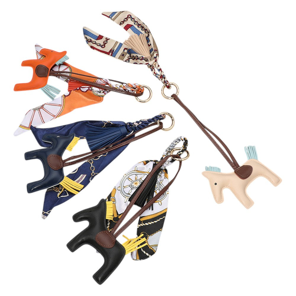 Black Faux Leather Horse Tassel Scarf Bag Charm. Made with high-quality faux leather, this elegant charm is designed to add a touch of sophistication to your favourite bag. The intricate horse design and tassel detail make it a unique accessory that will surely elevate your style.