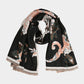A soft scarf featuring an elegant floral print with a bordered edge and fringe finish. Lightweight yet cozy, this versatile accessory brings warmth and a touch of sophistication to casual and dressy outfits.