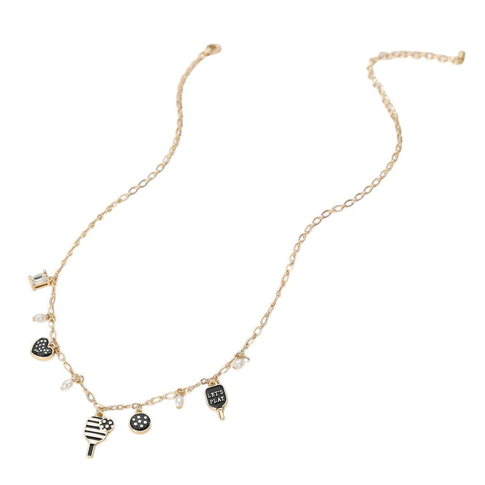 Black Gold White Let's Play Message Enamel Pickleball Pearl Charm Station Necklace is a must-have for any pickleball enthusiast. The stunning pearl charm and enamel design add a touch of elegance, while the "Let's Play" message promotes a sense of fun and camaraderie. Show off your love for this popular sport with style and grace.