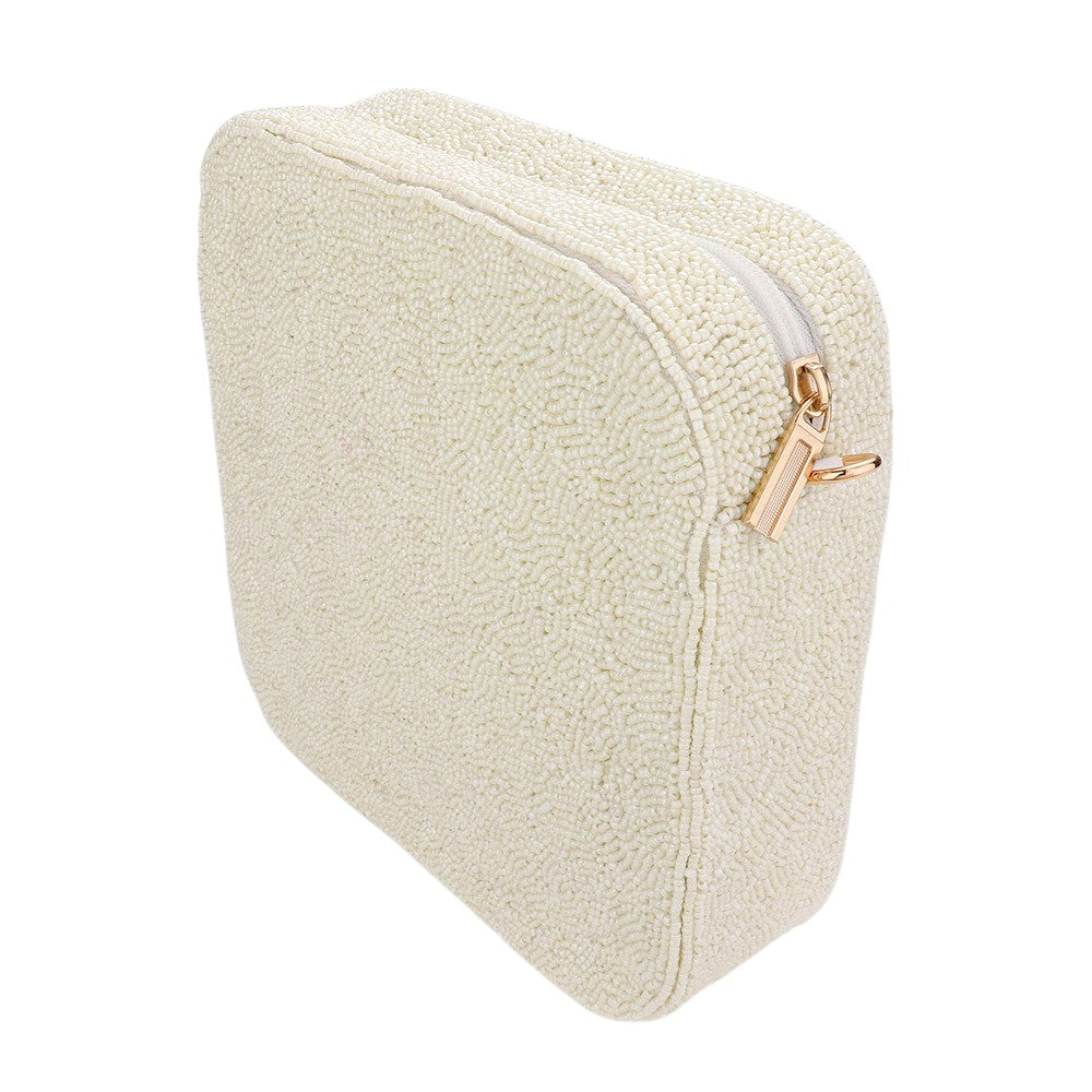 Heart accented crossbody bag is adorned with delicate seed beads, adding a touch of elegance to any outfit. The compact square shape is perfect for carrying your essentials, while the crossbody strap keeps your hands free. The unique design and quality materials make it a must-have accessory for any fashion-forward individual.
