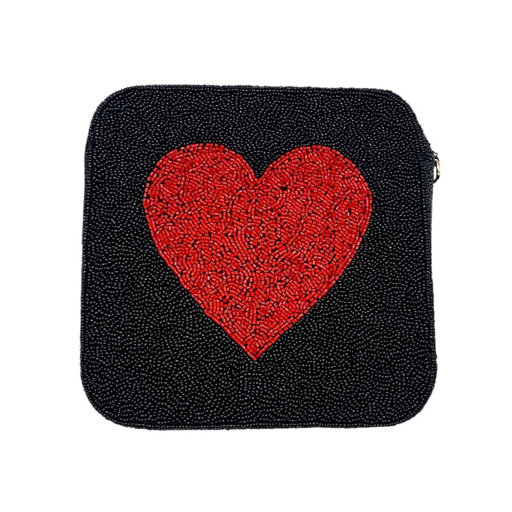 Black Pink Heart accented crossbody bag is adorned with delicate seed beads, adding a touch of elegance to any outfit. The compact square shape is perfect for carrying your essentials, while the crossbody strap keeps your hands free. The unique design and quality materials make it a must-have accessory for any fashion-forward individual.