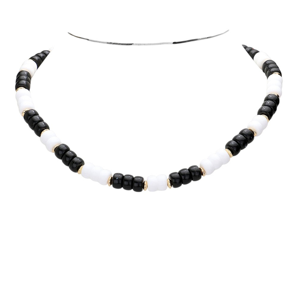 Black White Chunky Beaded Necklace is a versatile and stylish accessory for any outfit. Made with chunky beads, it adds a touch of elegance and texture to your look. Its bold design makes a statement while being comfortable to wear. Elevate your fashion sense with this eye-catching necklace.