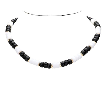 Black White Chunky Beaded Necklace is a versatile and stylish accessory for any outfit. Made with chunky beads, it adds a touch of elegance and texture to your look. Its bold design makes a statement while being comfortable to wear. Elevate your fashion sense with this eye-catching necklace.