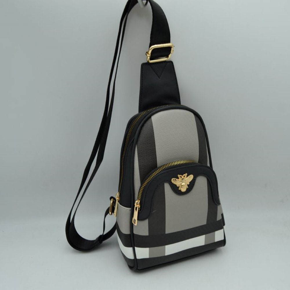 Black This functional sling bag showcases a geometric panelled pattern across the exterior, making it a distinct choice for active everyday use. It features multiple practical storage compartments, including a curved main zippered section and a smaller front pouch highlighted by a detailed metallic bee emblem. Designed with a single broad strap style, it connects to a metallic buckle at the top to allow for a versatile, over-the-shoulder carry layout.
