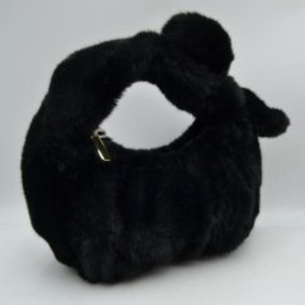 Black This unique handbag features a fluffy, plush texture across its entire exterior, offering a soft and tactile finish for distinctive everyday use. It showcases a slouchy, curved silhouette highlighted by an integrated top handle that features a prominent twist knot detail on one side. The open-top design allows for quick and convenient access to the main storage compartment, making it a playful yet functional accessory for carrying your daily essentials.