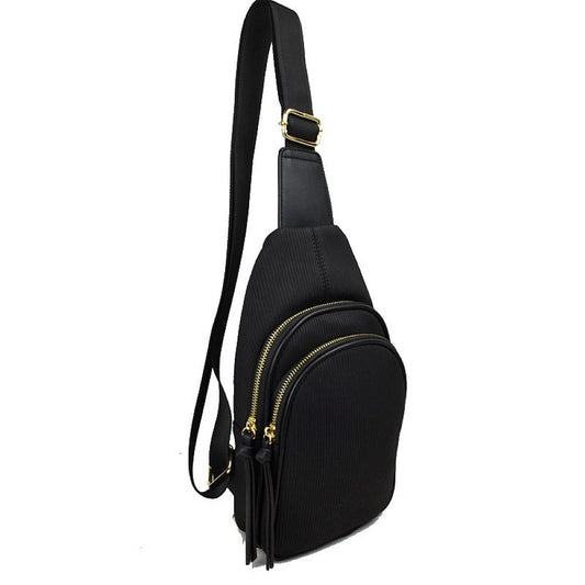 Black This practical sling bag features a textured, finely ribbed exterior w/ a tapered silhouette designed for comfortable everyday use. It offers organized storage compartments, including a curved main zippered section and a matching smaller front zippered pouch, both enhanced by elongated vertical tassel pulls hanging from the sliders. The bag is equipped w/ a single wide fabric shoulder strap attached to a smooth top panel & secured w/ a metallic adjustment buckle to easily customize the carrying length