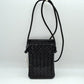 Black This compact vertical crossbody bag is designed for everyday functionality with a distinct woven textured pattern across its body. It features a slim, continuous cord strap attached securely to the sides with visible knot details for comfortable carrying. A clean horizontal opening at the top allows effortless access to the main storage compartment
