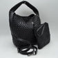 Black This stylish everyday hobo bag features an all-over classic basket weave design and a slouchy silhouette. It is crafted with a seamless, integrated wide top handle that transitions directly into the main storage compartment for comfortable hand or shoulder carrying.